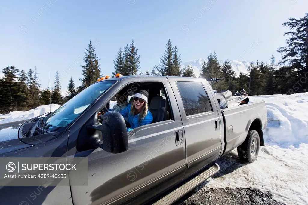 Lynsey Dyer Backing Up Her Ford F-350 To Unload Her Snowmobile For Some Backcountry Skiing, Late Winter, Chugach Mountains, Southcentral Alaska.