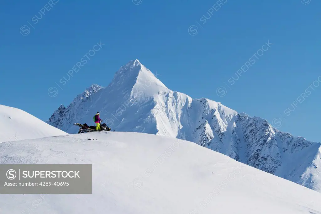 Lynsey Dyer Scoping Her Route Backcountry Skiing By Snowmobile In The Chugach Mountains Late Winter, Southcentral Alaska.