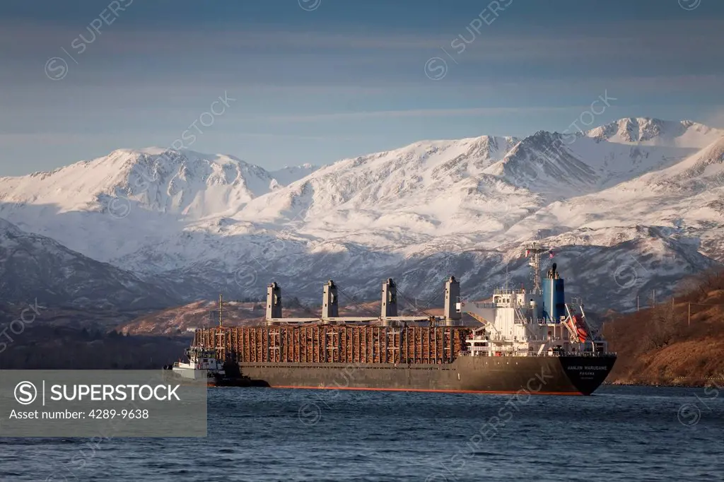 Panamanian ship Hanjin Marugame, assisted by a tug boat, departs Womens Bay, Kodiak Island, Southwest Alaska, Autumn
