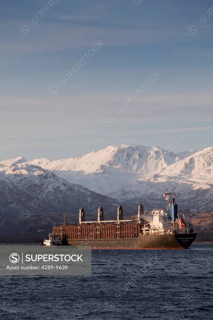 Panamanian ship Hanjin Marugame, assisted by a tug boat, departs Womens Bay, Kodiak Island, Southwest Alaska, Autumn