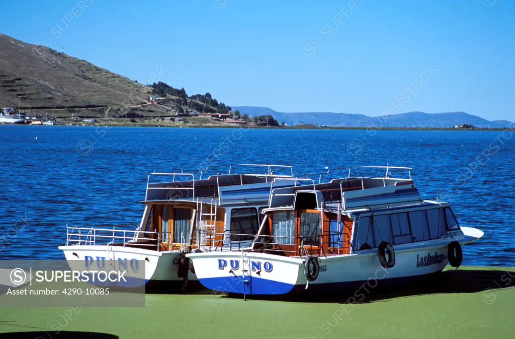 Two boats moored in Puno Harbour, on Lake Titicaca, Puno, Peru