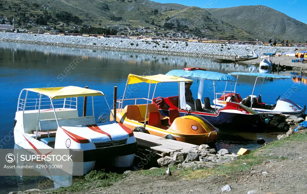 Row of colourful pleasure boats moored in Puno Harbour, on Lake Titicaca, Puno, Peru