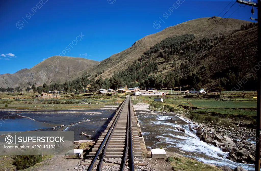 Railway track and bridge over river, Andes mountain range, Puno to Cusco Perurail train journey, Peru
