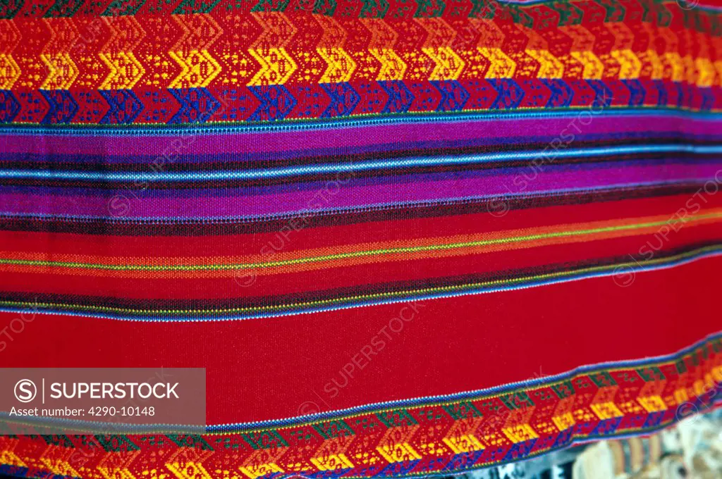 Colourful woven striped fabric for sale in Pisac Market, Pisac, near Cusco, Peru