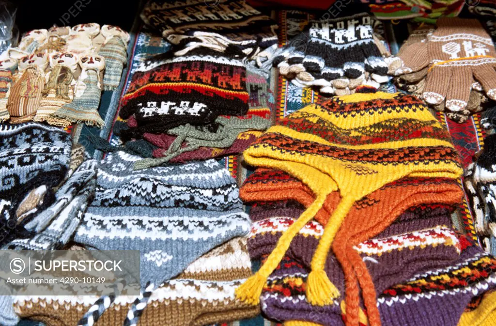 Colourful woollen hats for sale on stall in Pisac Market, Pisac, near Cusco, Peru