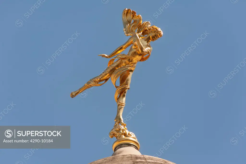 Golden statue of Shakespeare's Ariel on a dome of the Bank of England, London, England