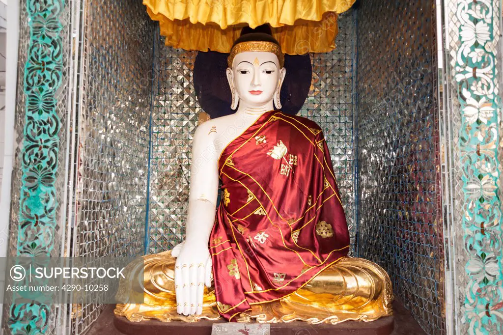 A colourful Buddha statue at Shwedagon Pagoda, Yangon, (Rangoon), Myanmar, (Burma)