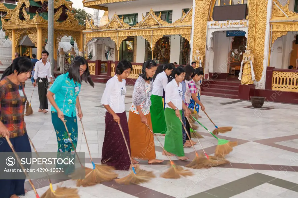 Women sweeping tiled floor at Shwedagon Pagoda, Yangon, (Rangoon), Myanmar, (Burma)