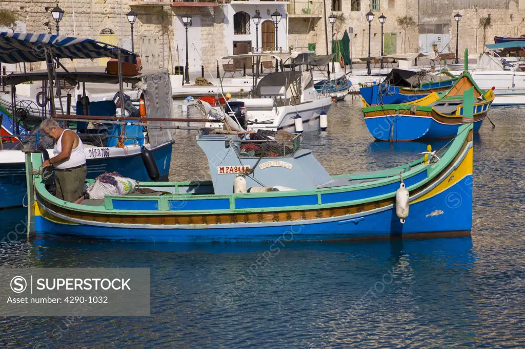 Luzzu fishing boat moored in Saint Julians Harbour, Spinola Bay, Saint Julians, Malta