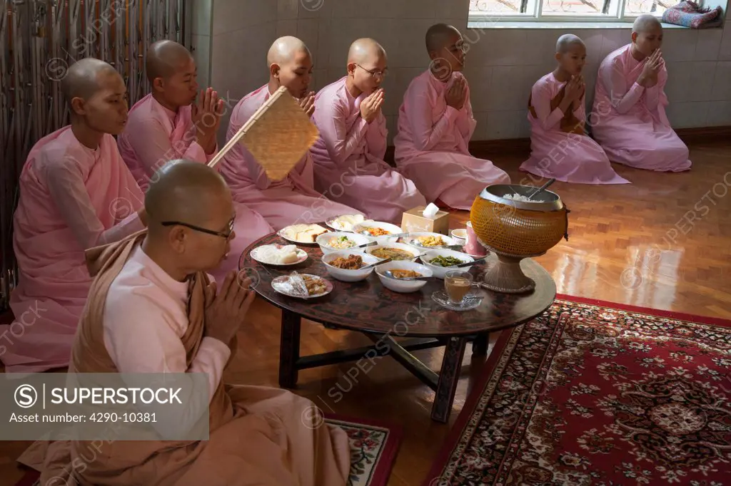 Nuns praying before eating, Sakyadhita Thilashin Nunnery School, Sagaing, near Mandalay, Myanmar, (Burma)