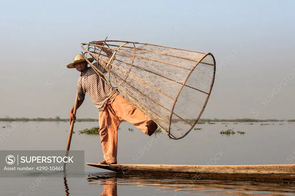 Intha fisherman holding traditional fishing net, Inle Lake, Nyaung Shwe, Shan State, Myanmar, (Burma)