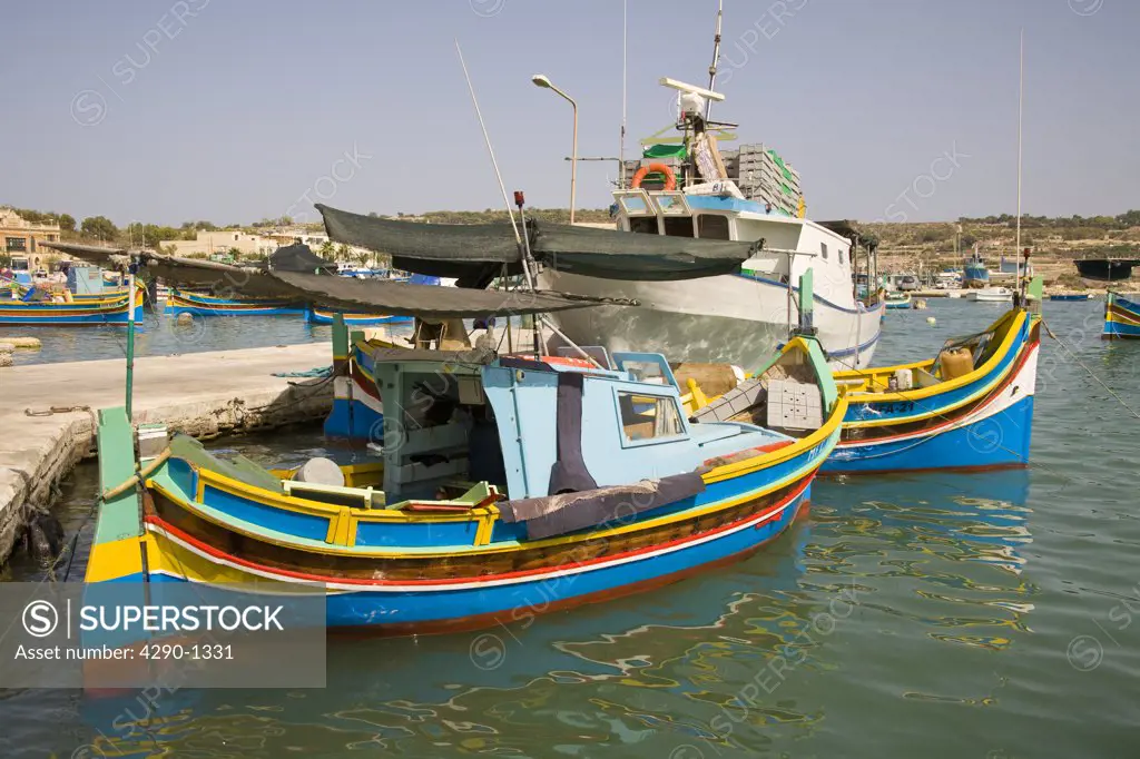 Luzzu fishing boats moored in Marsaxlokk Harbour, Marsaxlokk, Malta