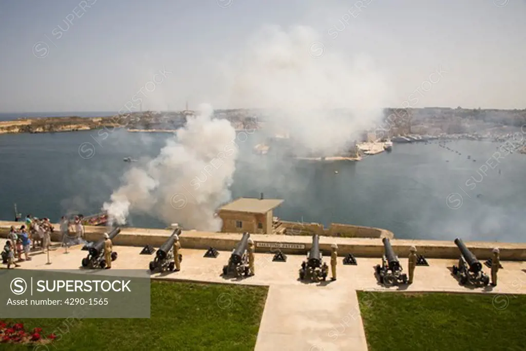 Firing of the noon day gun, at the Saluting Battery, Upper Barracca Gardens, Valletta, Malta