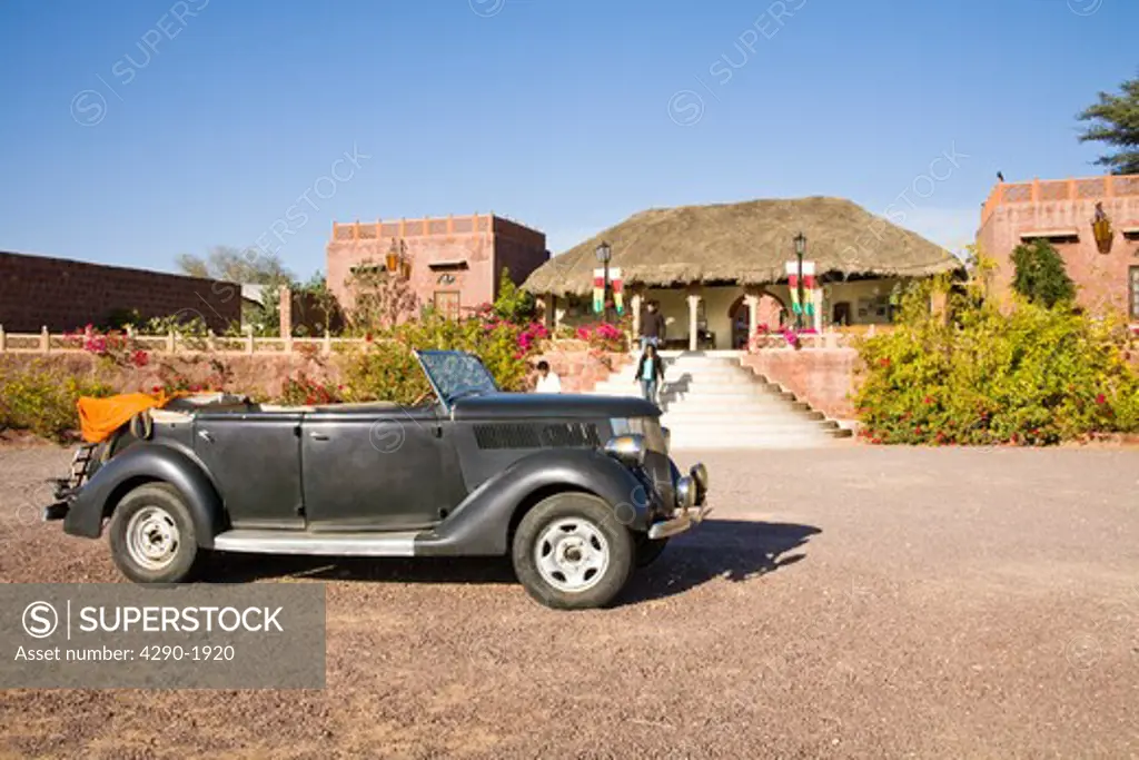Old car in front of the reception area at Osian Camel Camp, Osian, Rajasthan, India