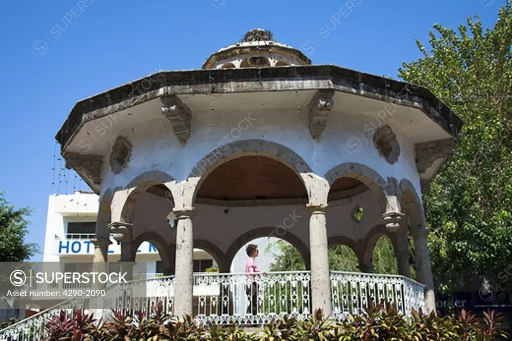 Tourist standing on bandstand, Zocalo, Acapulco, Guerrero State, Mexico