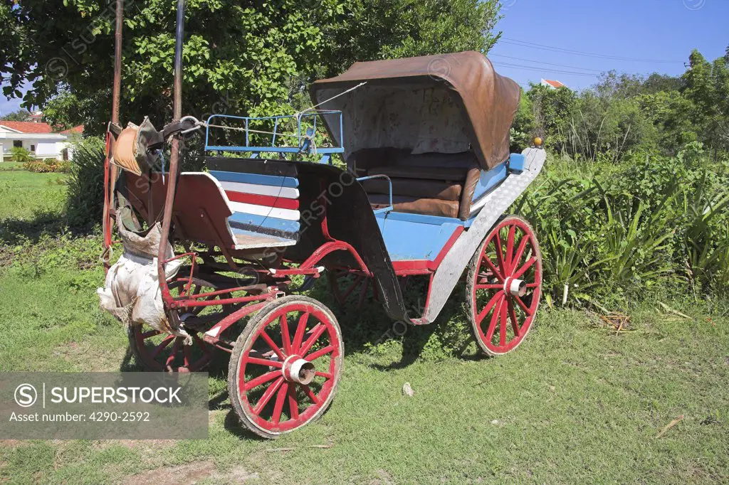Old horsedrawn wooden carriage in a garden, Guardalavaca, Holguin Province, Cuba