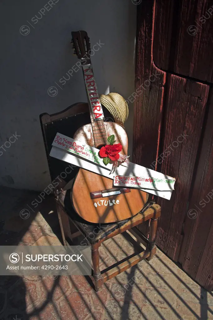 Old guitar on chair, Casa de la Trova, location for traditional Cuban music, Bayamo, Granma Province, Cuba