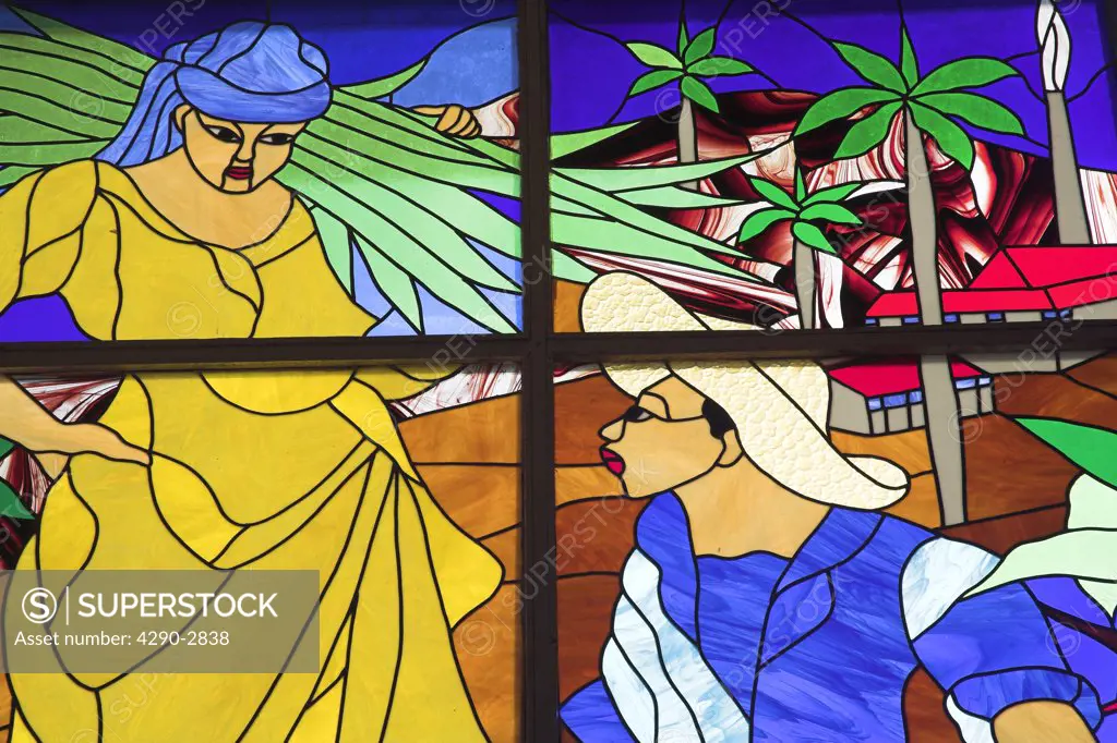 Colourful stained glass window of woman carrying farming produce on her shoulder, Trinidad, Cuba