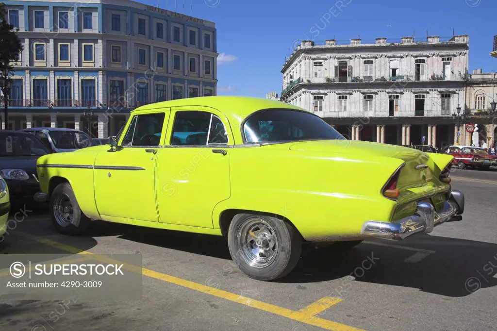 Classic American yellow Plymouth car parked in the road, Havana, La Habana Vieja, Cuba
