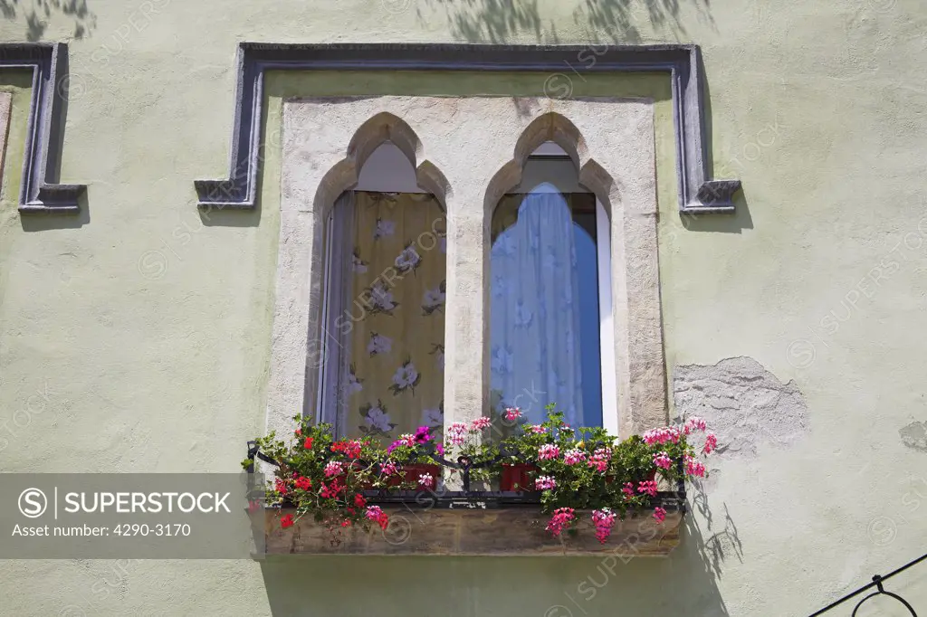 Old gothic style window on building in the old town, Sighisoara, Transylvania, Romania