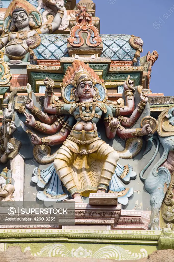 Carved figure with eight arms on a gopuram, Meenakshi Temple, Madurai, Tamil Nadu, India