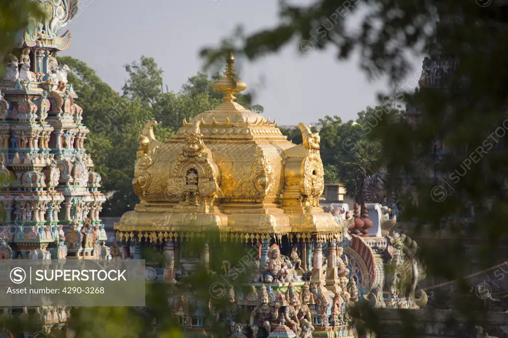 Looking through trees to Golden tower of Meenakshi Temple, Madurai, Tamil Nadu, India