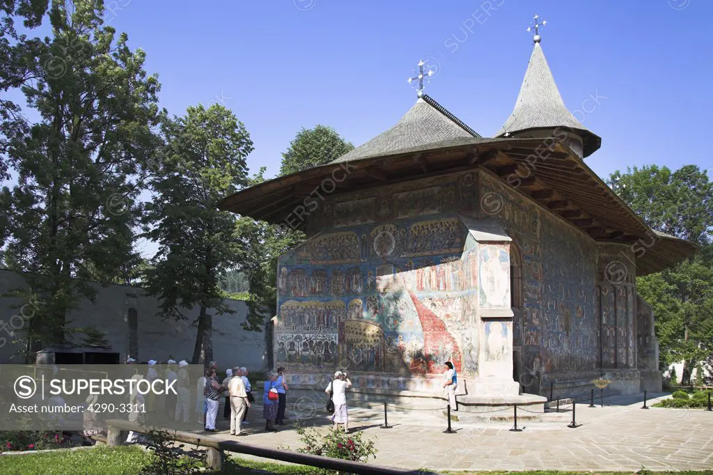 Tourists outside Voronet Monastery, near Gura Humorului, Bucovina, Moldavia, Romania