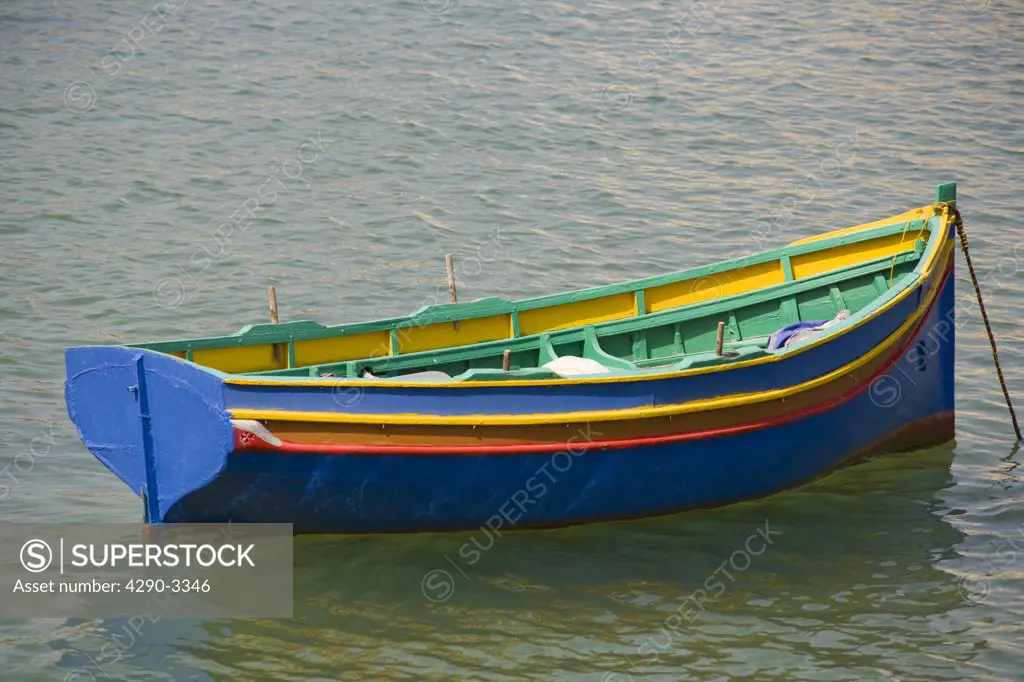 Colourful rowing boat moored in the harbour, Marsascala, Malta