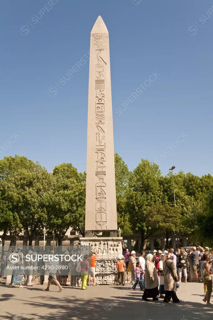 Tourists visiting the Egyptian Obelisk in the Hippodrome, Istanbul, Turkey