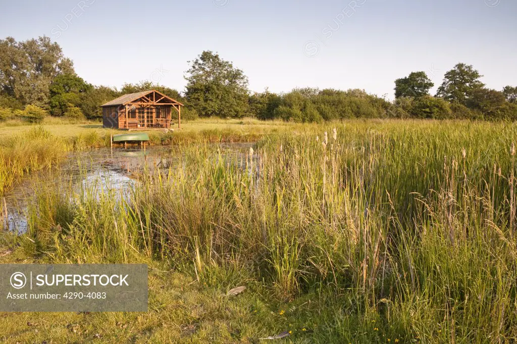 Large pond and summerhouse in the countryside, Wiltshire, England