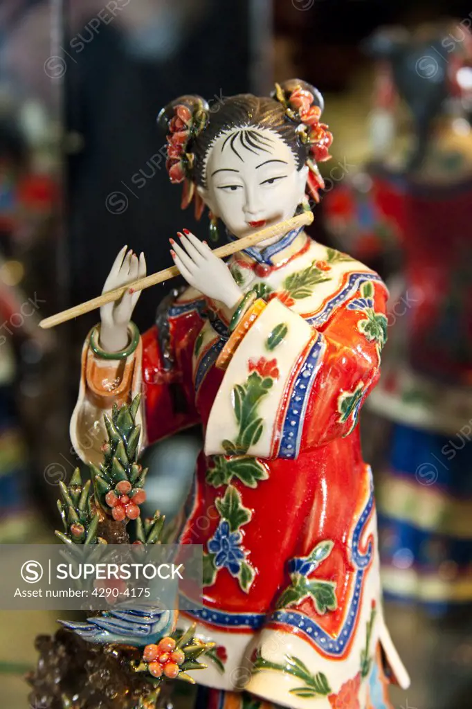 Painted jade carving of a Chinese woman playing a flute, Beijing, China