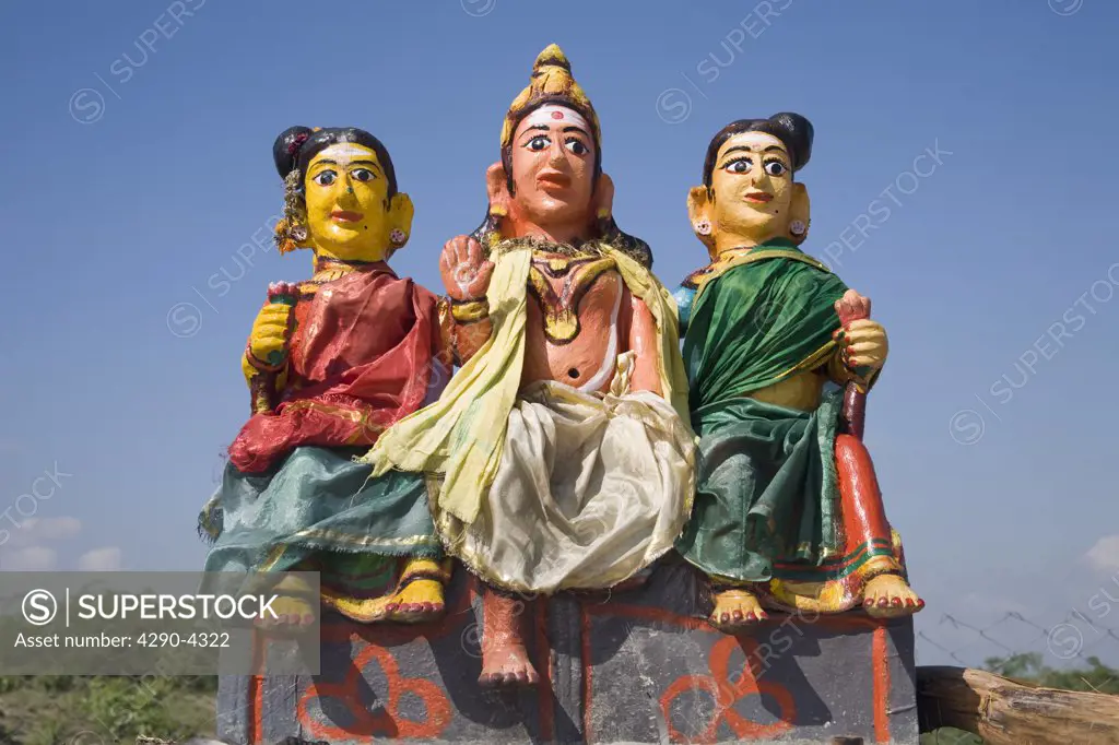 Colourful religious statue depicting three women at a Hindu Shrine, Tamil Nadu, India