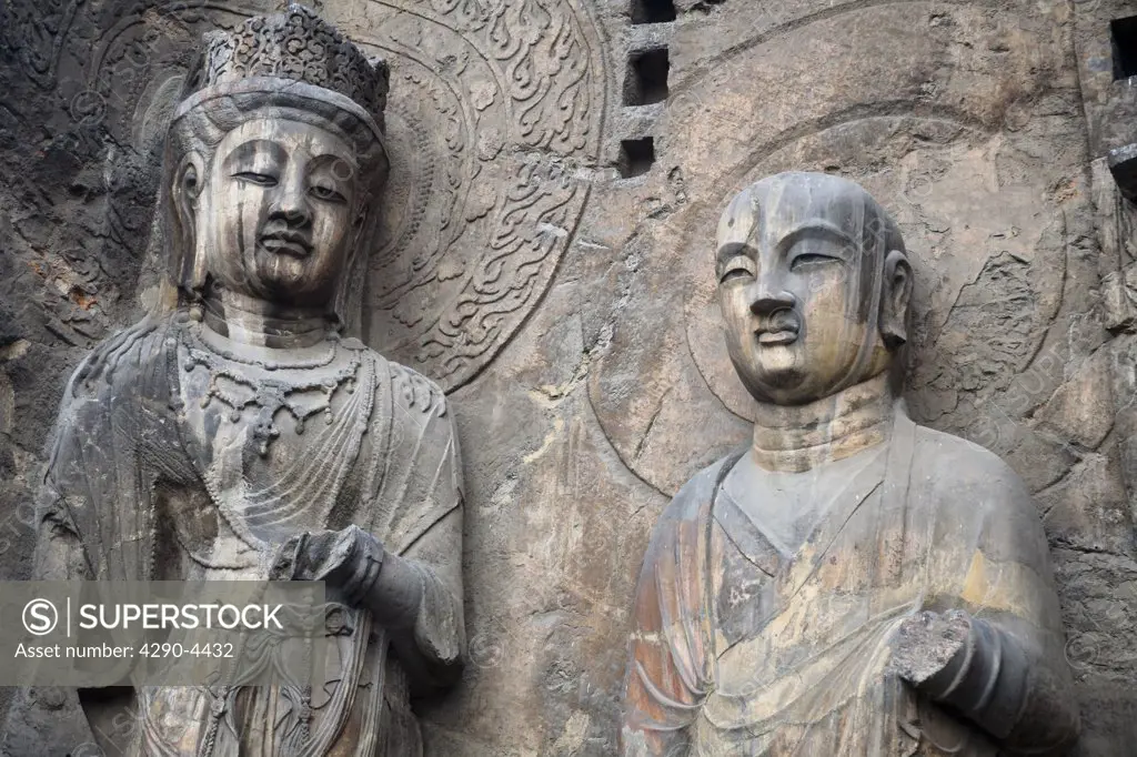 Carved Buddhist statues, Fengxian Temple, Longmen Grottoes and Caves, Luoyang, Henan Province, China. Tang Dynasty