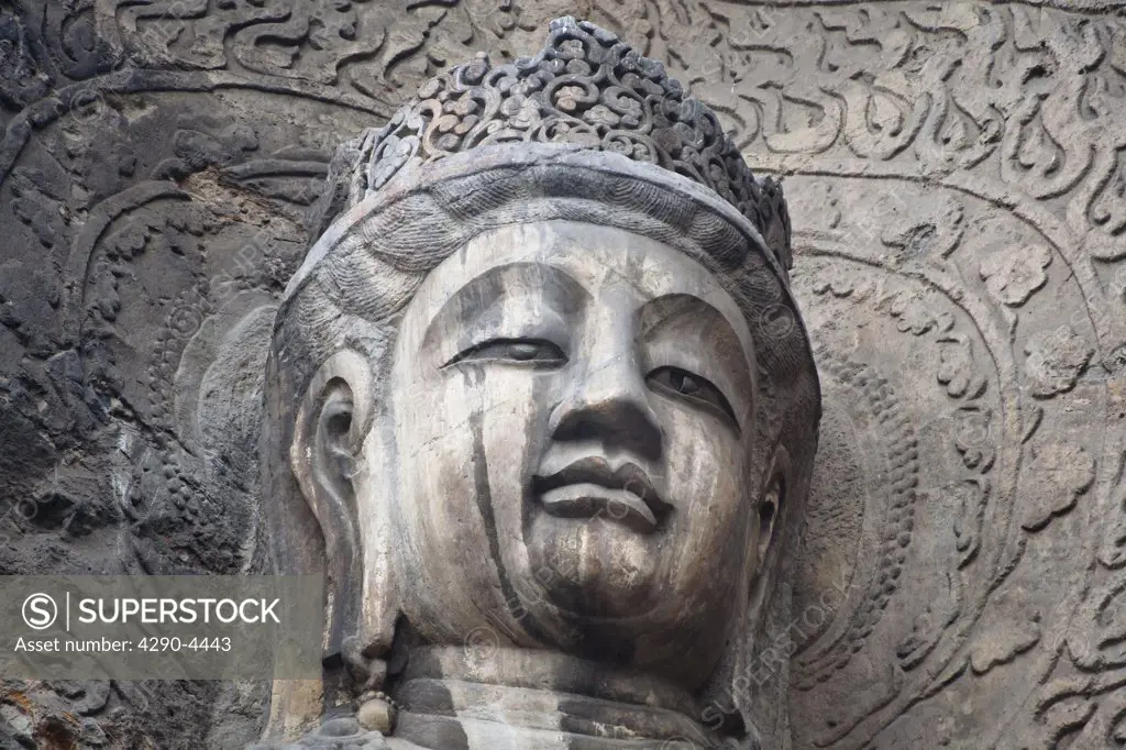 Carved Buddha statue, Fengxian Temple, Longmen Grottoes and Caves, Luoyang, Henan Province, China. Tang Dynasty