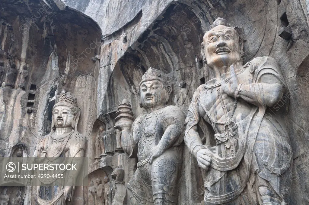 Carved statues, Fengxian Temple, Longmen Grottoes and Caves, Luoyang, Henan Province, China. Tang Dynasty