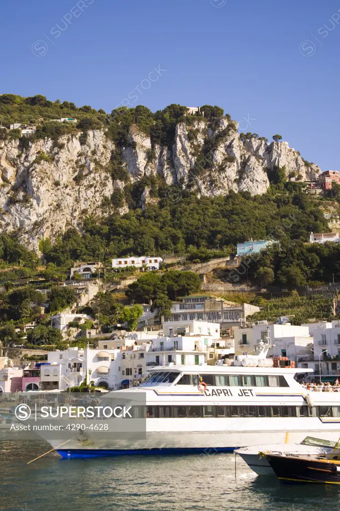View of harbour, cruise boat, buildings and mountains, Marina Grande, Capri, Italy