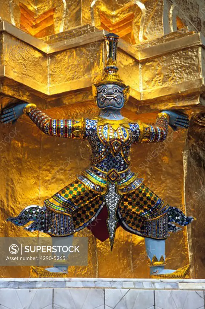 Guardian mythical demon supporting golden chedi, Grand Palace, Bangkok, Thailand