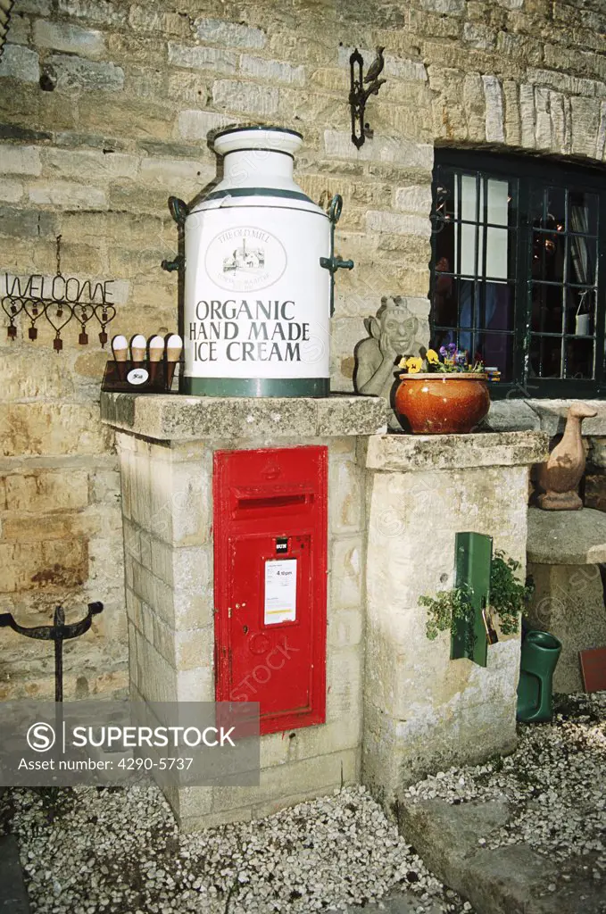 Milk churn and post box, The Old Mill, Lower Slaughter, Cotswolds, Gloucestershire, England