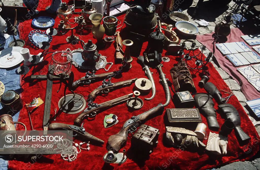 Guns and other antiques for sale, Campo de Santa Clara street market, Alfama District, Lisbon, Portugal