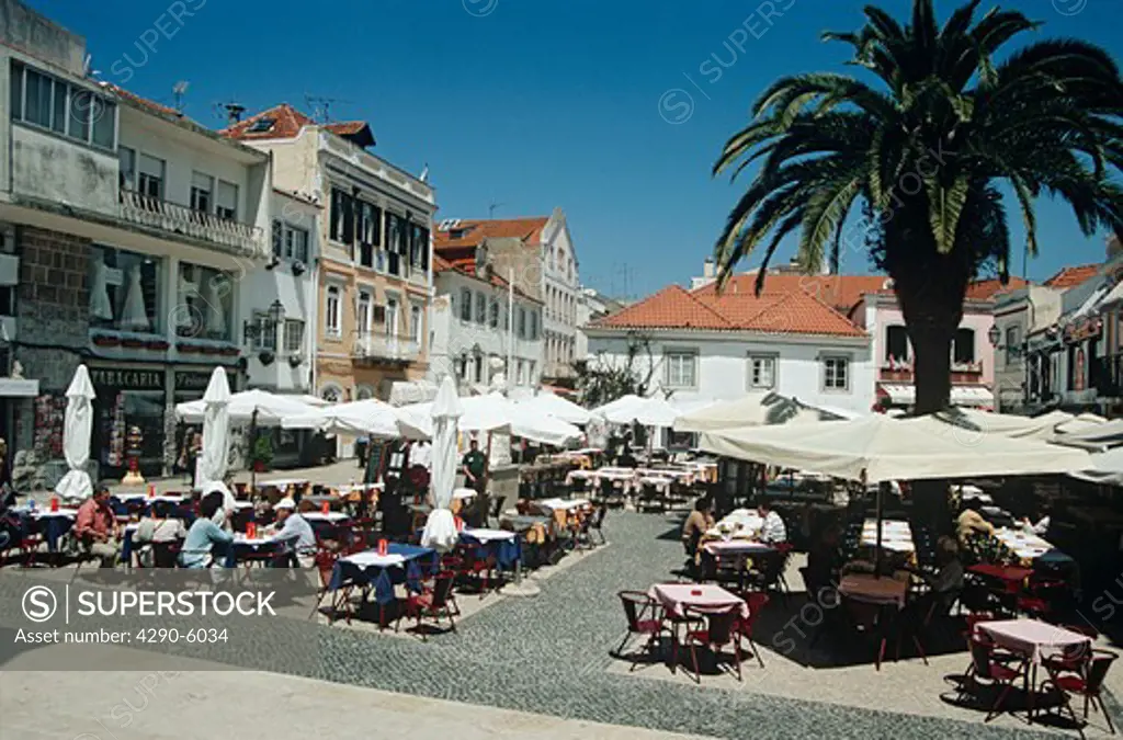 Diners dining outside a restaurant in Rua da Palma, one of the town squares, Cascais, near Lisbon, Portugal