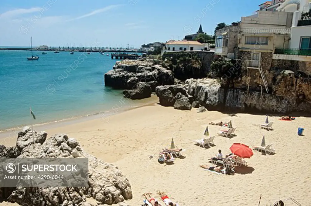 View of people sunbathing on one of the beaches, Cascais, near Lisbon, Portugal