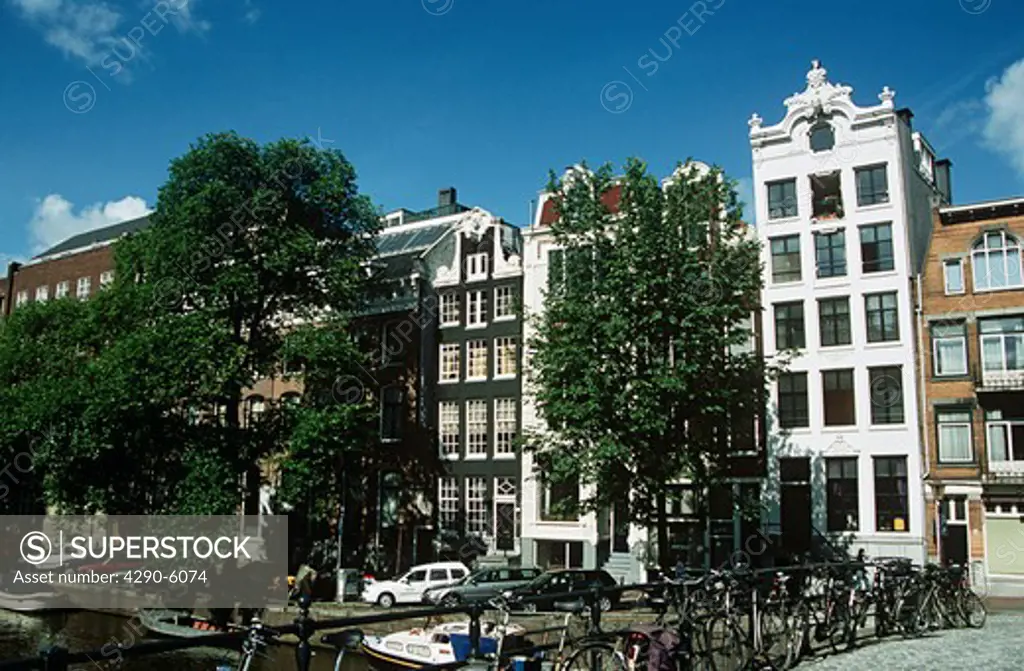 Houses overlooking canal, bicycles on bridge, Amsterdam, Holland