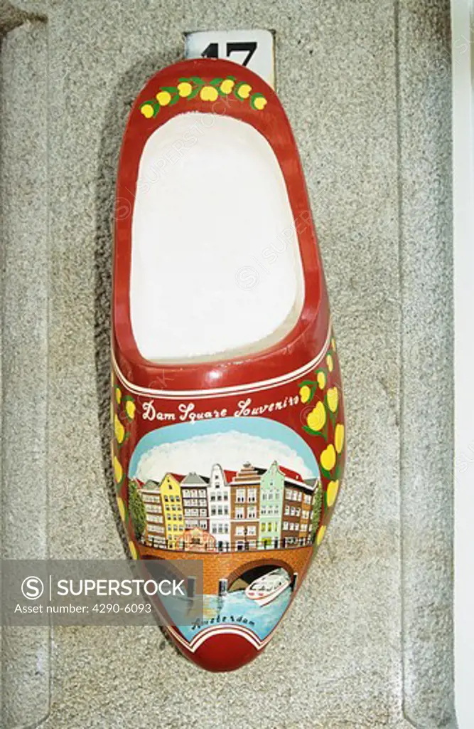 Large wooden souvenir clog hanging outside a house, Amsterdam, Holland