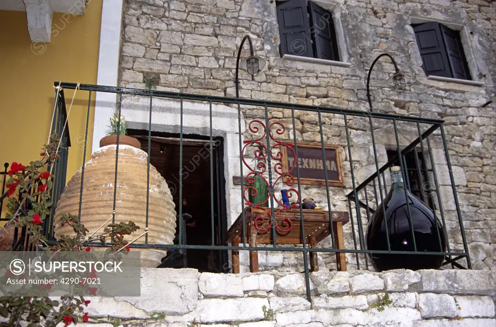 Pot, table and demijohn on balcony, Texnhma gift shop, Kioni, Ithaca, Greece