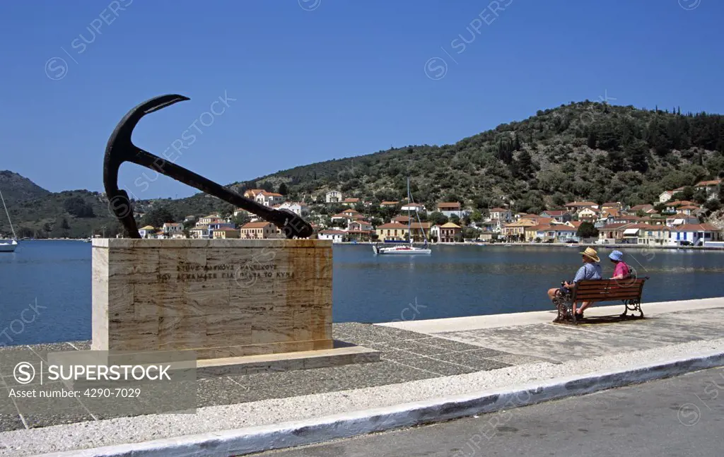 Anchor, tribute to those who have died at sea, and harbour, people on seat, Vathi, Ithaca, Greece