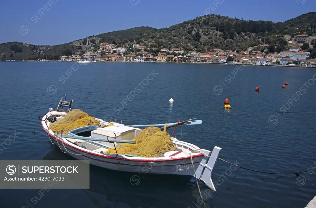 Boat moored in harbour and Vathi town behind, Vathi, Ithaca, Greece
