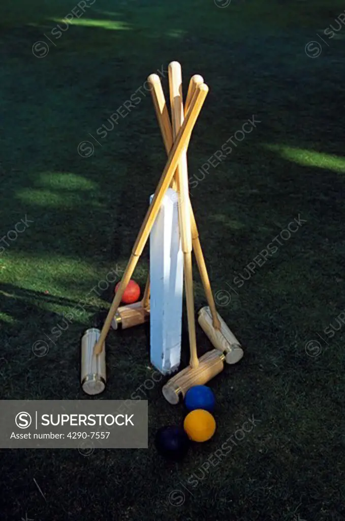 Croquet mallets and balls on lawn, Castle Coombe, Wiltshire, England