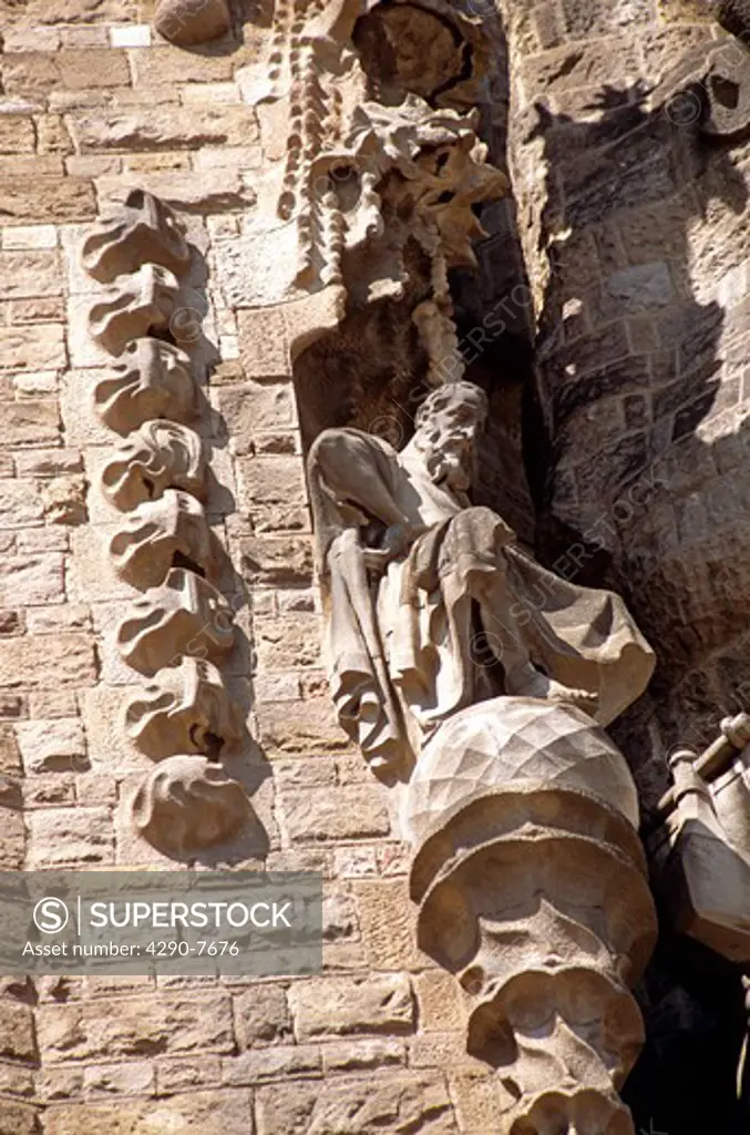 Exterior statue of old man sitting, La Sagrada Familia, Barcelona, Spain