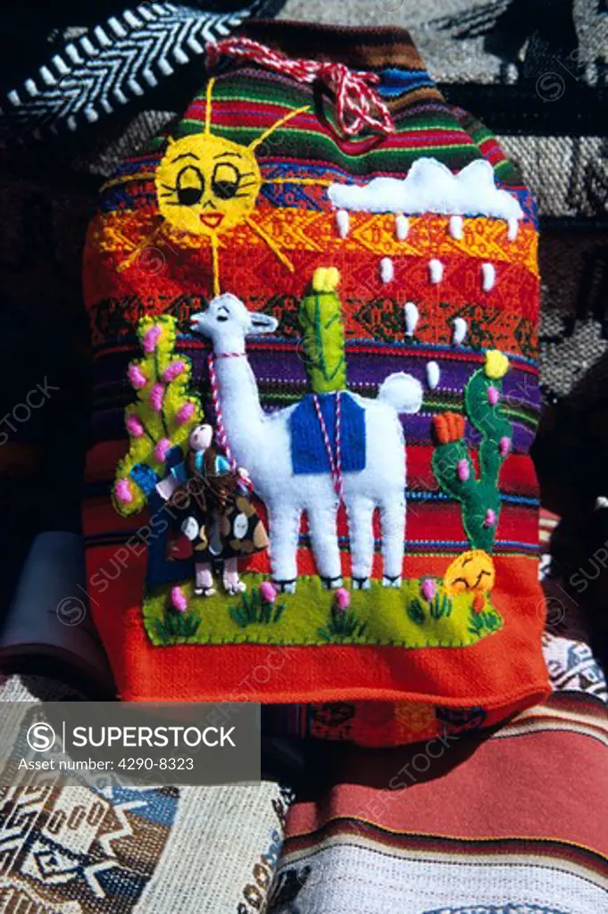 Colourful bag depicting alpaca or llama, in market, La Raya, Puno to Cusco Perurail train journey, Peru