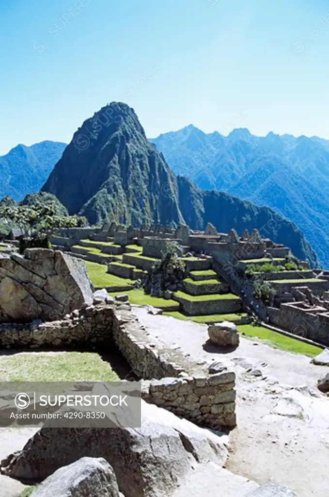 Machu Picchu Inca ruins and Huayna Picchu, wall in foreground, Peru